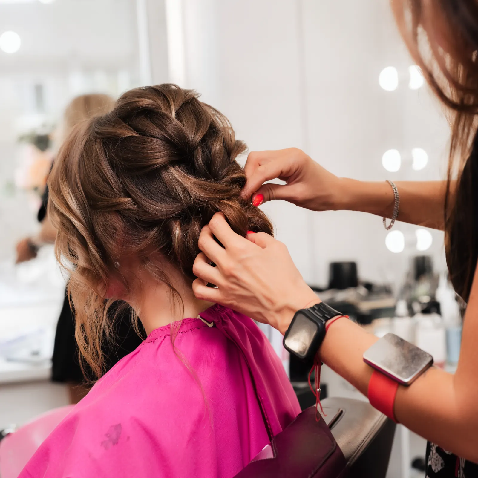 Bridal hair updo being styled on a model