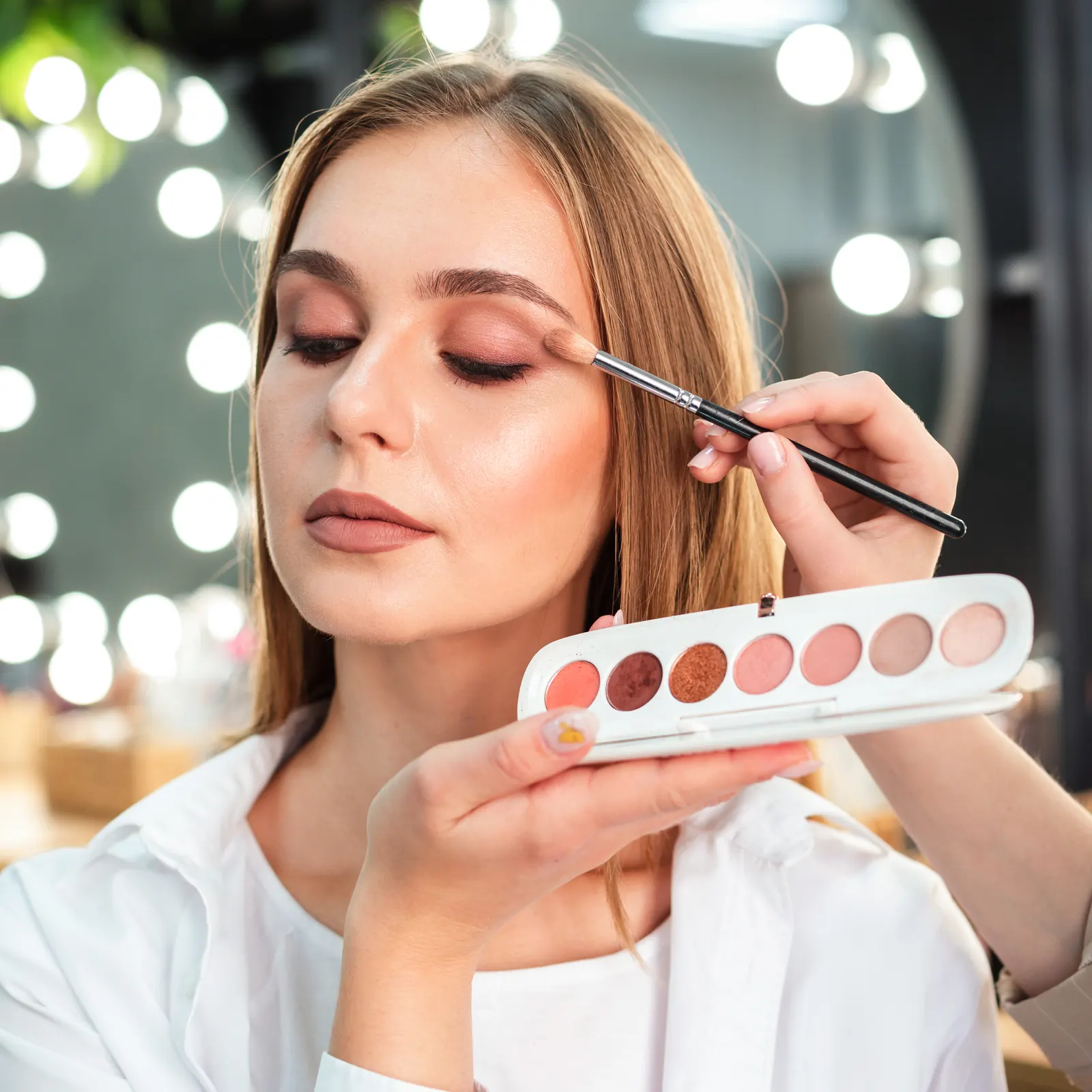 Student practising eyeshadow application in the makeup studio